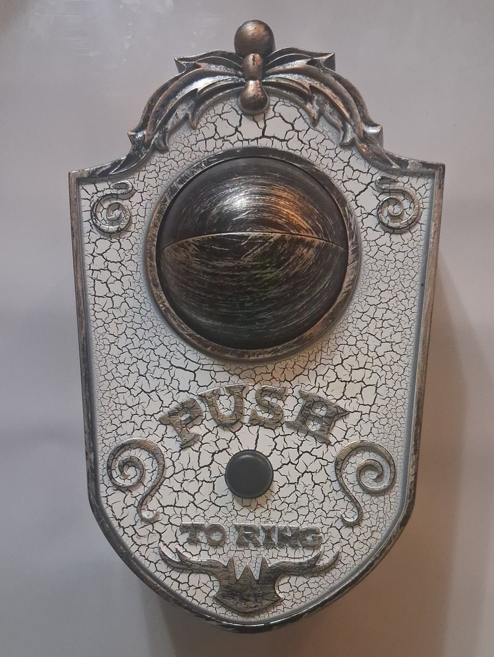 Gemmy Animated Eyeball Halloween Doorbell with a cracked antique white